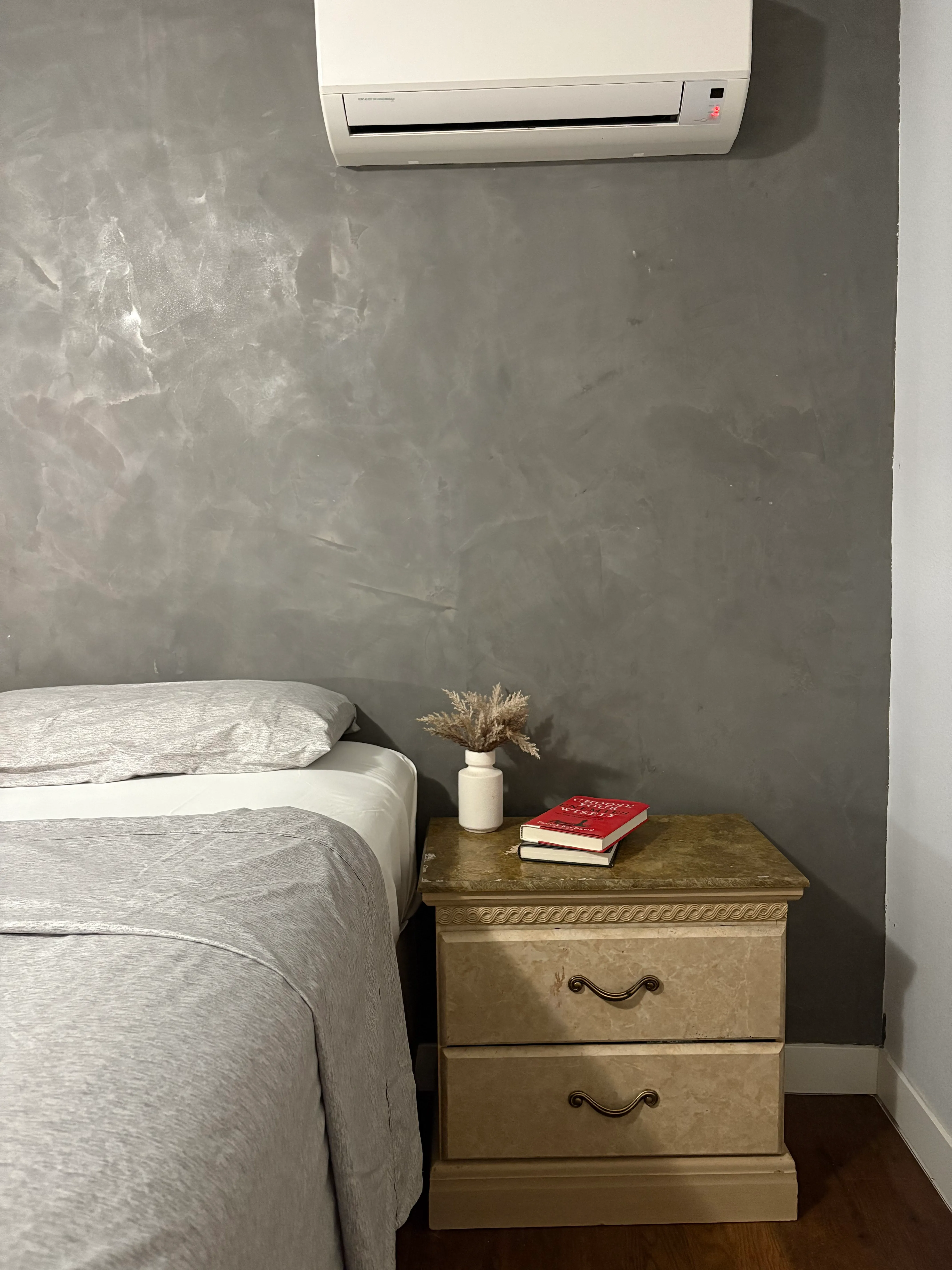 Fresco harmony bedroom accent wall with nightstand showing rich hand-applied texture detail