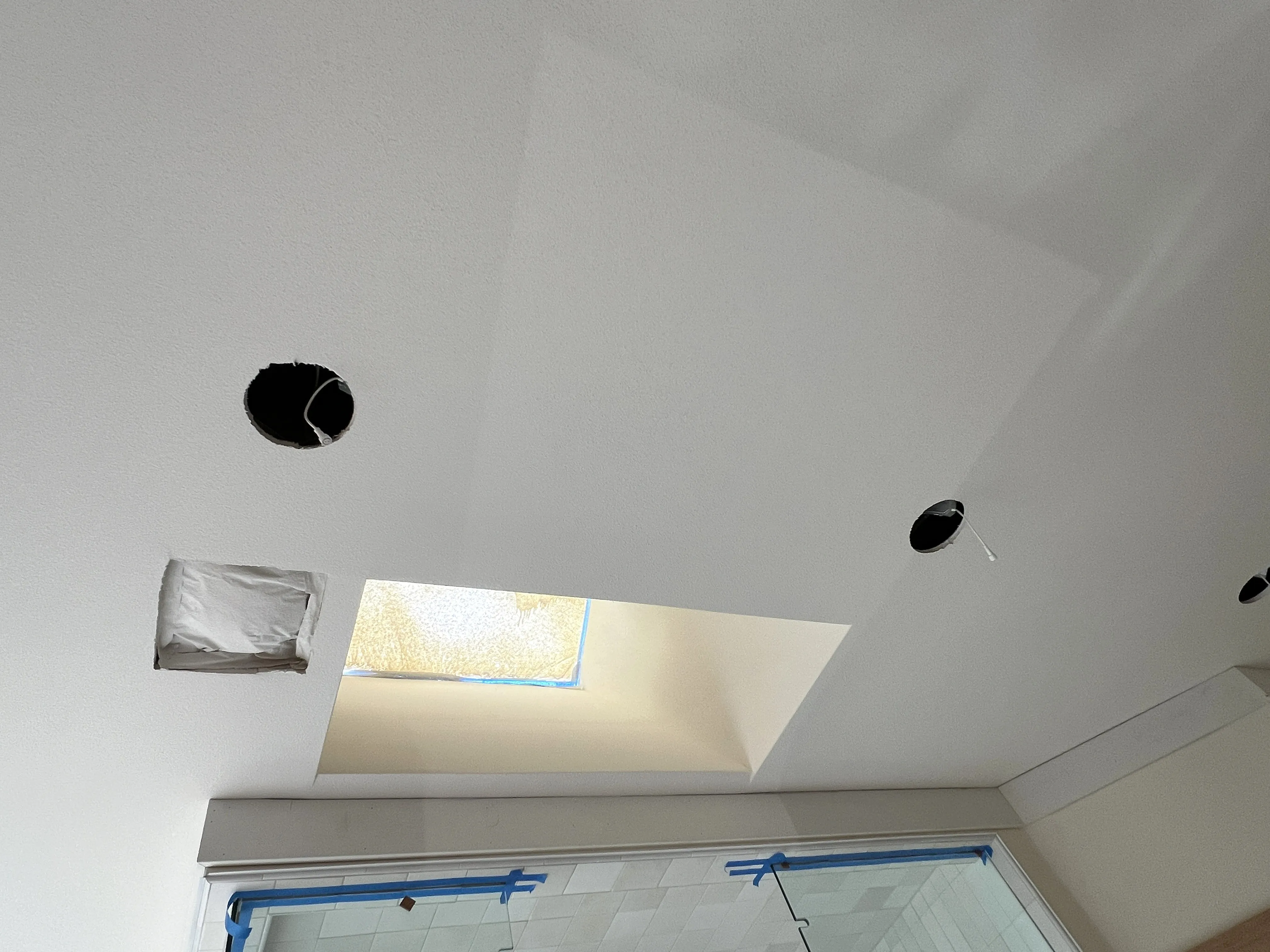 Ceiling with recessed lighting installed after popcorn ceiling removal and smooth finishing