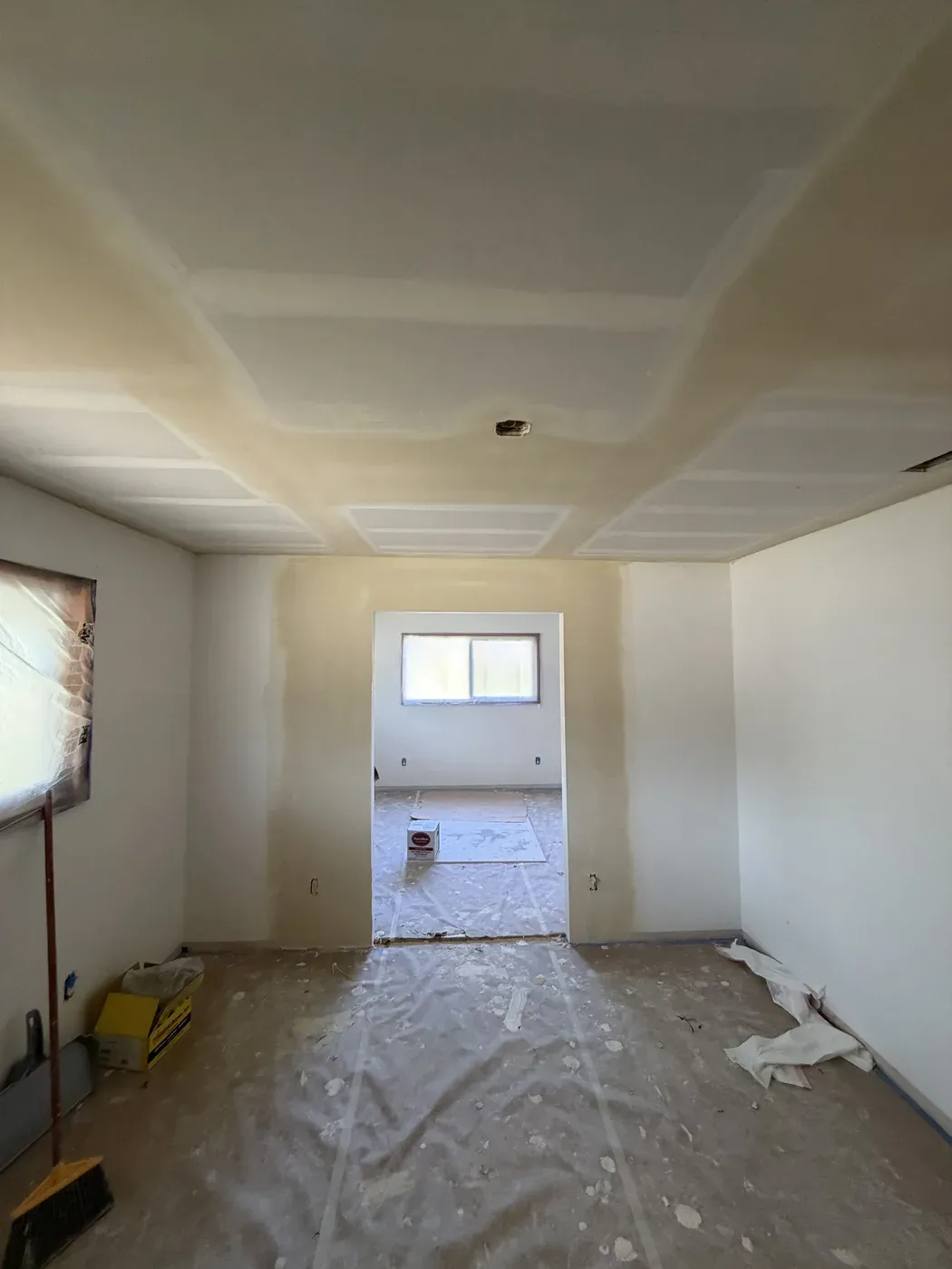 Taped ceiling drywall overlay above protected floors and windows in Vancouver WA