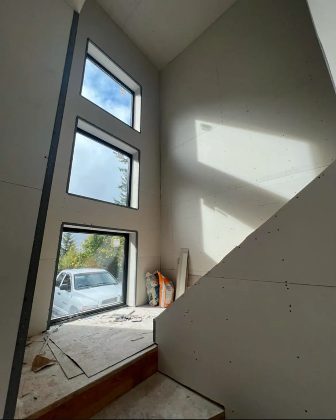 Multi-room drywall install with taping in progress