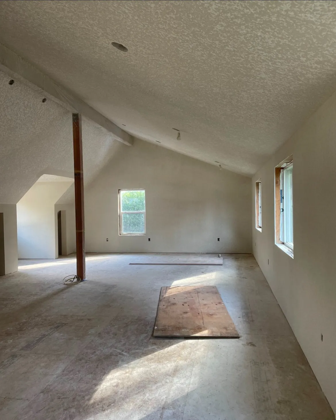 Drywall installation in two-story foyer with high ceilings