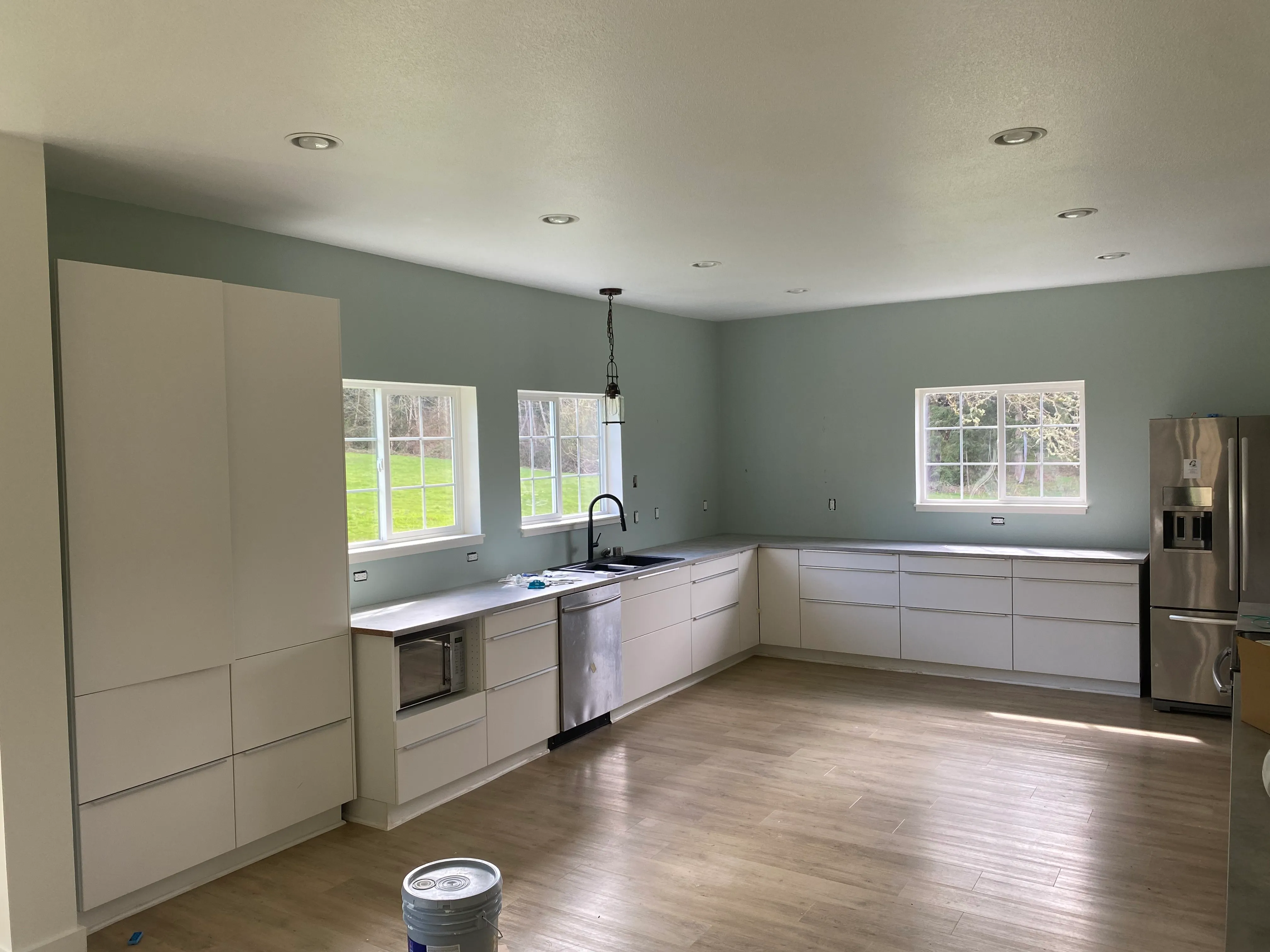 Professional interior painting by AvilaCo Drywall showing clean cut lines on kitchen walls