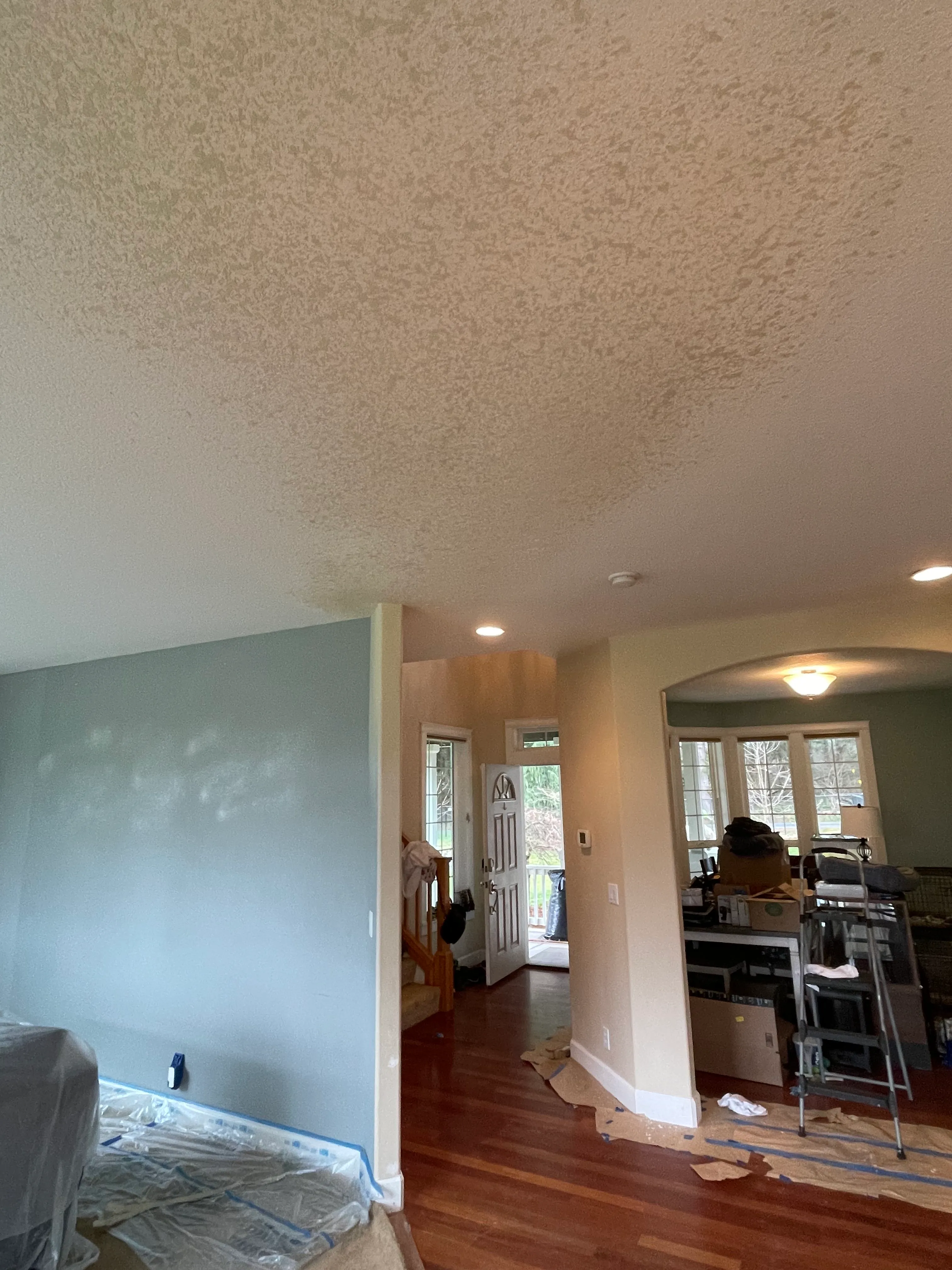 Living room drywall repair and texture matching in progress in a Clark County home